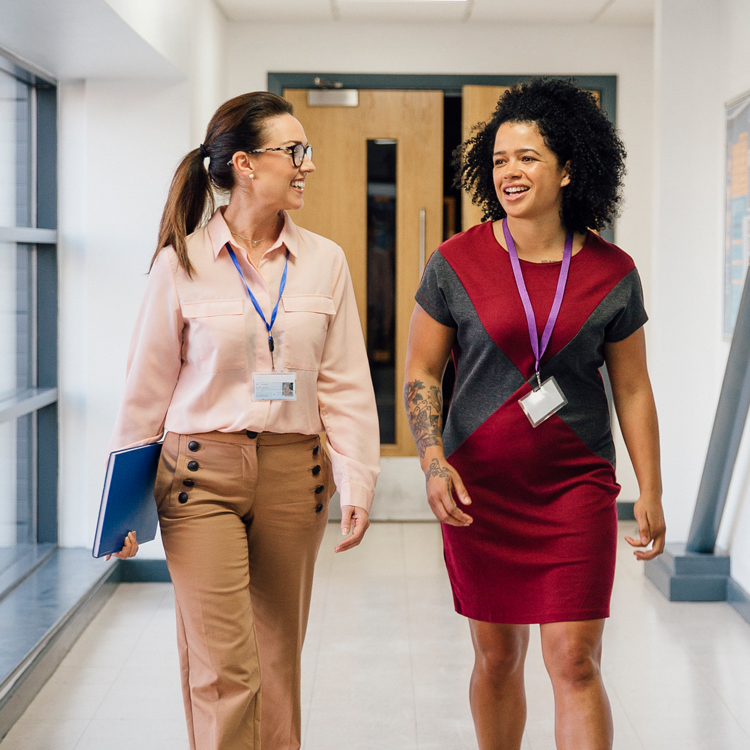 2 female teachers walking through school