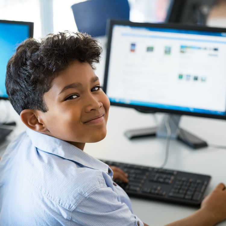 Happy boy using a computer