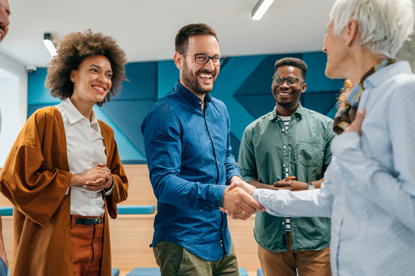 Happy people meeting shaking hands