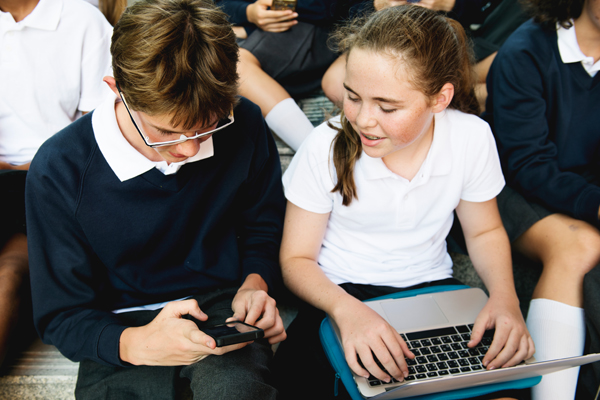 School children using devices