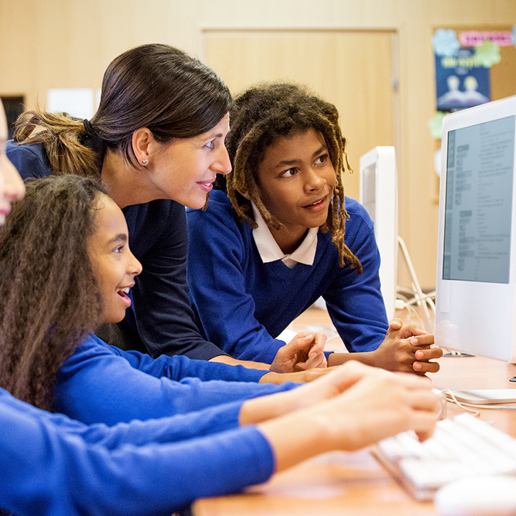 Students and teacher around a computer